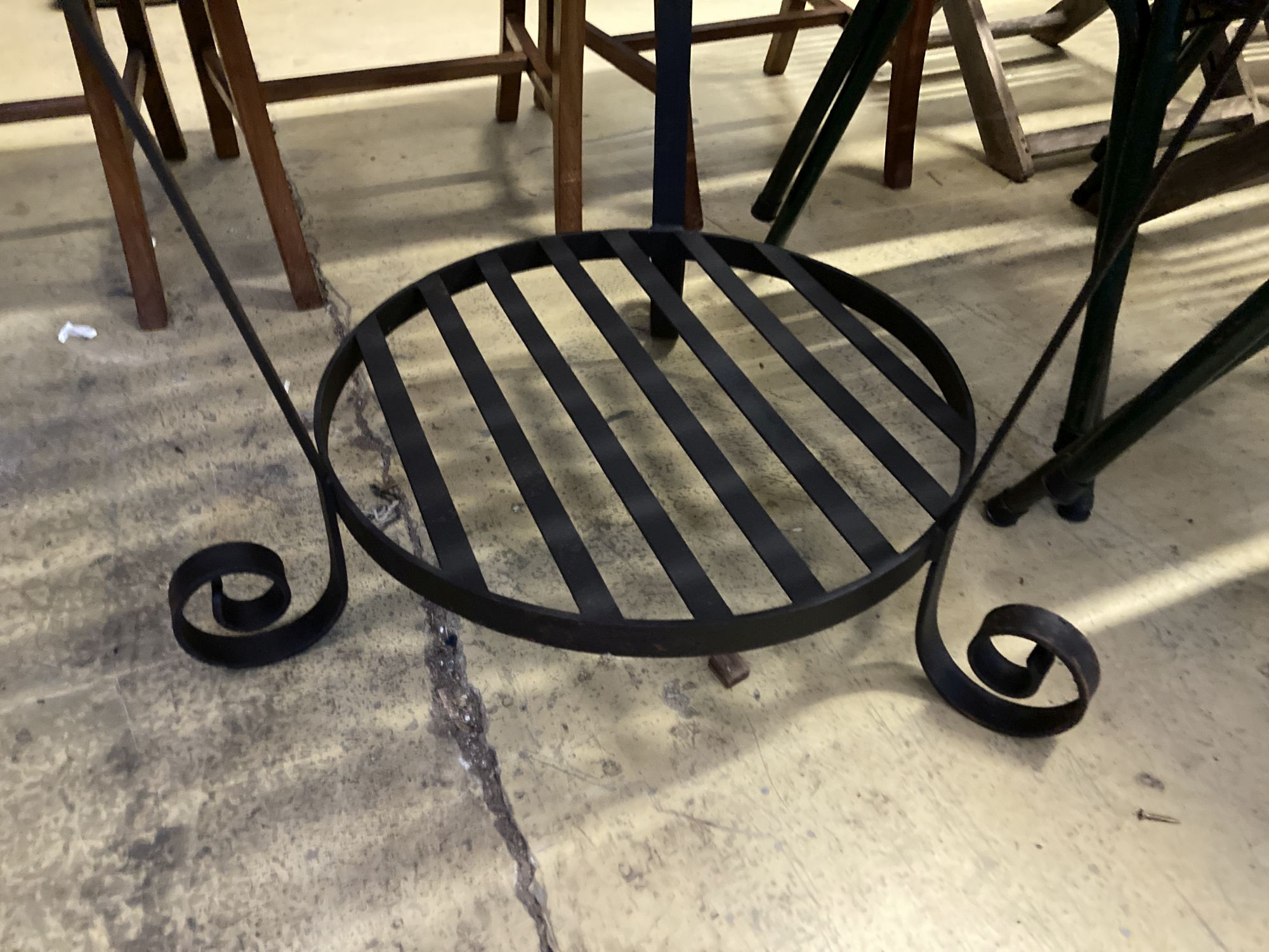 A circular slatted wood and wrought iron garden table, 85cm diameter, height 78cm together with a set of four slatted metal stacking ga